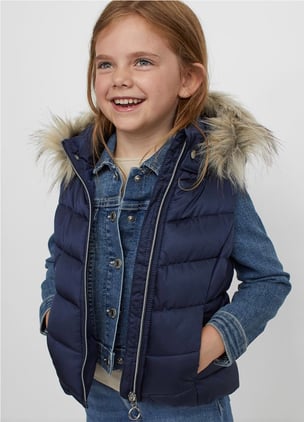 Little girl with puffy vest and jean jacket