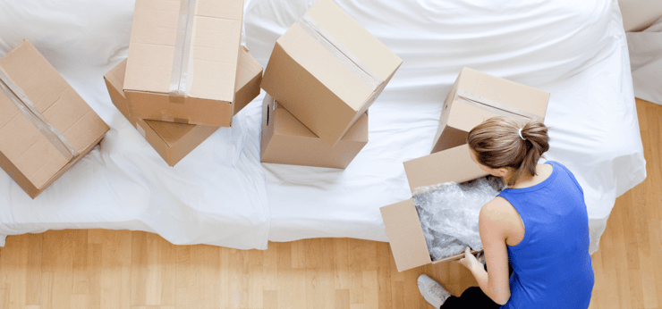 The Ultimate Moving Checklist woman packing image